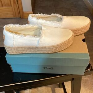 Tom’s white espadrilles